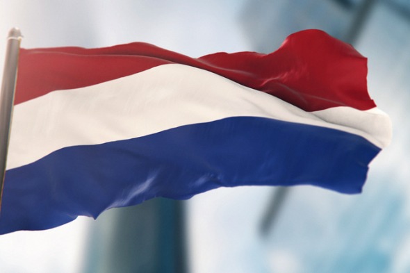 national-flag-of-netherlands-against-defocused-city-buildings-picture-id1291380859